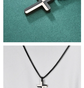 Macro detail of a black and white hex cross pendant with a sleek black chain necklace