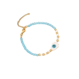Blue beaded bracelet with golden accents and Hamsa hand evil eye charm on white background