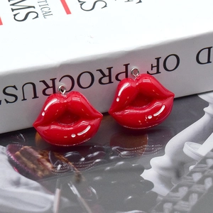 Detailed view of glossy red resin lip pendants for DIY earring and jewelry making