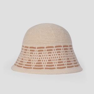 Close-up of knit texture and diamond pattern on cream white bucket hat for winter