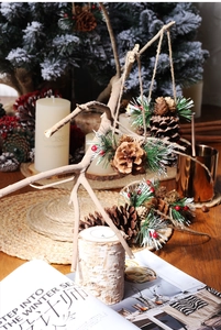 Natural pine cone ornaments with red berries and pine needles for Christmas DIY decor
