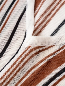 Detailed macro view of the V-neckline texture and striped linen blend knit fabric