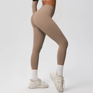 Detail of high-waisted seamless yoga pants in earth tone with matte texture and body shaping