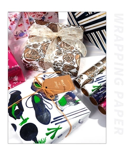 Close-up of heart and floral pattern gift wrapping paper rolls for Valentine's Day
