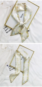 Detail of floral silk scarf with Be You text and elegant tie styling on a white shirt