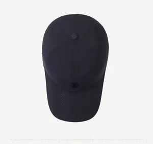 Top-down view of a black baseball cap with laser-cut ventilation holes and rubber logo