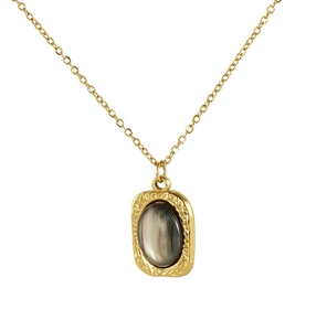 Macro detail of 18K gold-plated square pendant featuring a dark grey natural stone inlay