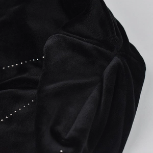 Detail of soft black chenille knit hat featuring rows of elegant pearl embellishments