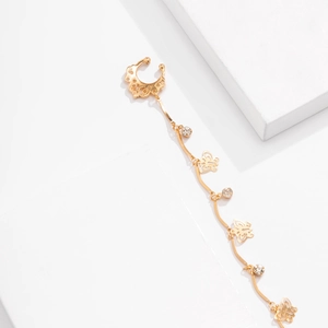 Detailed macro view of gold butterfly earring with long tassels and sparkling rhinestones