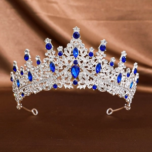 Close-up of bridal crown with blue gemstones and sparkling rhinestones on brown silk