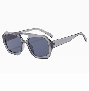 Detail view of translucent smoke grey aviator sunglasses with a classic double bridge design