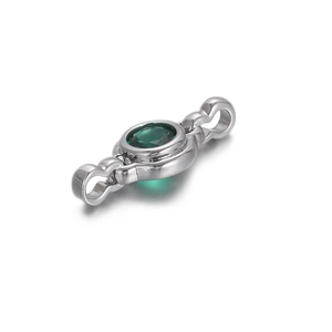 Macro shot of silver connector with green oval zircon for DIY jewelry making