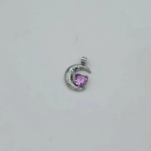 Detail of silver crescent moon pendant with purple heart stone and zircon accents