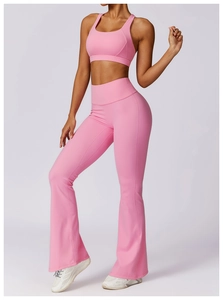 Detailed view of pink yoga set featuring a U-neck sports bra and high-waisted flared pants