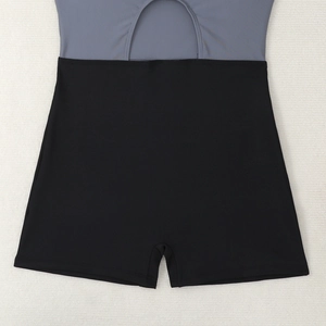 Detail of high-waist cutout design and grey-black contrast stitching on the swimsuit