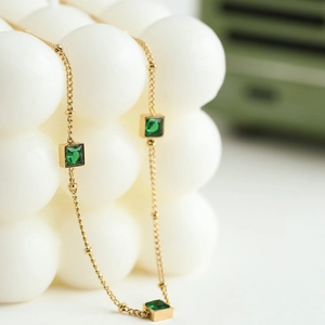 Elegant 18K gold plated necklace with three square green zircons on a fine chain