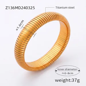 Detail of 1.6cm wide golden titanium steel Tubogas bracelet with spiral snake texture