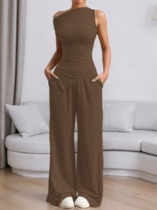 Detail of dark brown one-shoulder top and high-waist wide-leg pants two-piece set