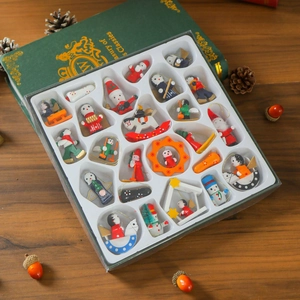 Detail of wooden Christmas ornaments set including Santa and rocking horse in a gift box