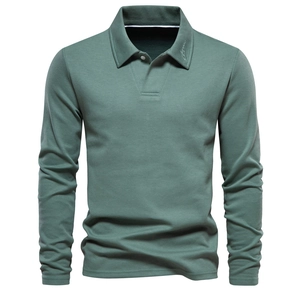 Detail of piqué cotton texture and embroidered collar on a long-sleeve polo in sage green
