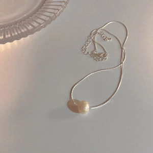 Elegant floral tassel pearl necklace with a minimalist silver chain and soft luster