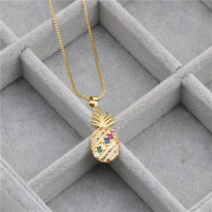 Detailed close-up of a gold pineapple pendant necklace with colorful zircon stones