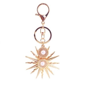 Baroque sunflower sun god keychain in gold finish with elegant pearl center accents
