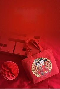 Detail of red wedding canvas gift bag featuring traditional bride and groom illustration