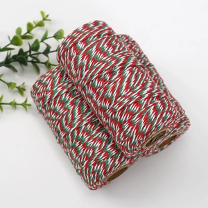 Macro detail of red green and white cotton twine rolls for Christmas gift wrapping