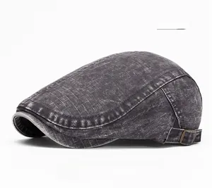 Detail of dark grey washed denim beret cap featuring adjustable metal side buckle