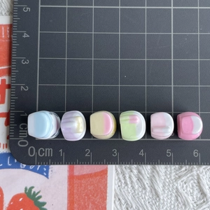 Macro shot of miniature colorful resin juice bottles measured on a scale mat