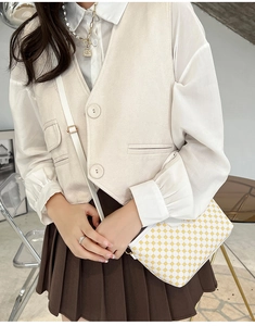 Crossbody small square bag with yellow geometric polka dots on white leather styled on model
