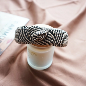 Detail of French vintage raffia woven knot headband with black and white patterns
