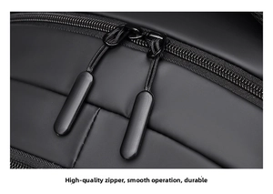 Macro detail of the smooth matte black dual zipper on a durable travel backpack