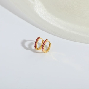 Gold plated hoop earrings with micro-paved pink zircons on a white minimalist background
