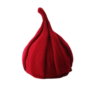 Cute red knitted garlic-shaped hat for children with twist top and thick yarn texture