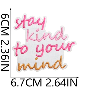 Detail of embroidered patch featuring Stay Kind to Your Mind quote in pink and orange