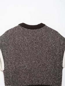 Close-up of herringbone knit pattern and ribbed neckline on brown knit vest top