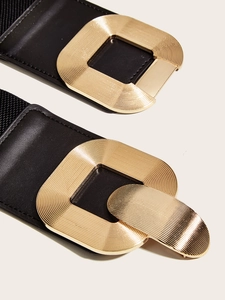 Elastic black waist belt for women with a textured gold rectangular metal buckle