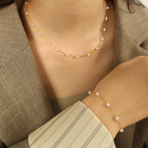 Nordic minimalist gold jewelry set with white pearls, including necklace and bracelet
