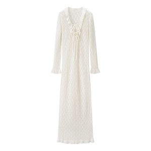 White knit hollow-out long dress with V-neck, ruffles, and lace-up front detail