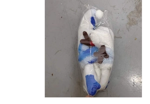 Christmas gnome doll with long legs and antlers packed in a clear protective plastic bag