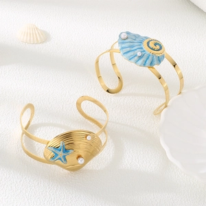 Ocean-themed stainless steel open bangles with gold shells, blue enamel and pearls