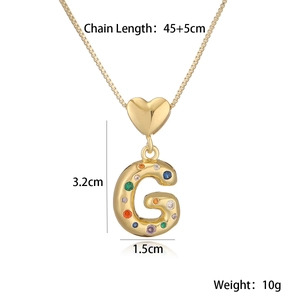 Detail showing 18K gold plated heart and G letter pendant with colored gemstones