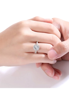 Close-up of elegant S925 silver moissanite ring with round center stone and pave accents