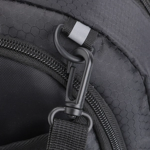 Macro view of water-resistant honeycomb fabric with D-ring hook and reflective strap
