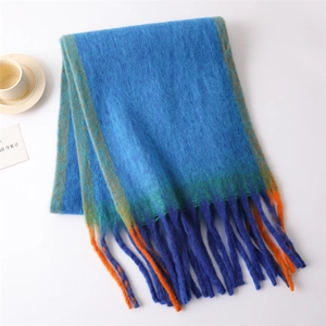 Close-up of soft blue knit scarf with orange stripes and fringe detail on white background
