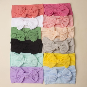 Set of 12 colorful soft nylon bow headbands for baby girls in various pastel shades