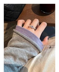 Detail of a square purple gemstone ring with pearls and pavé stones on a silver band