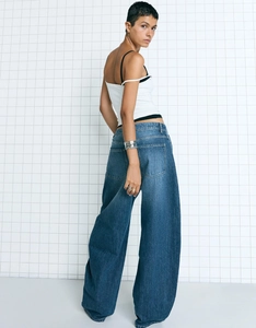Close-up of high-waist loose wide-leg jeans in dark blue wash denim with retro cut